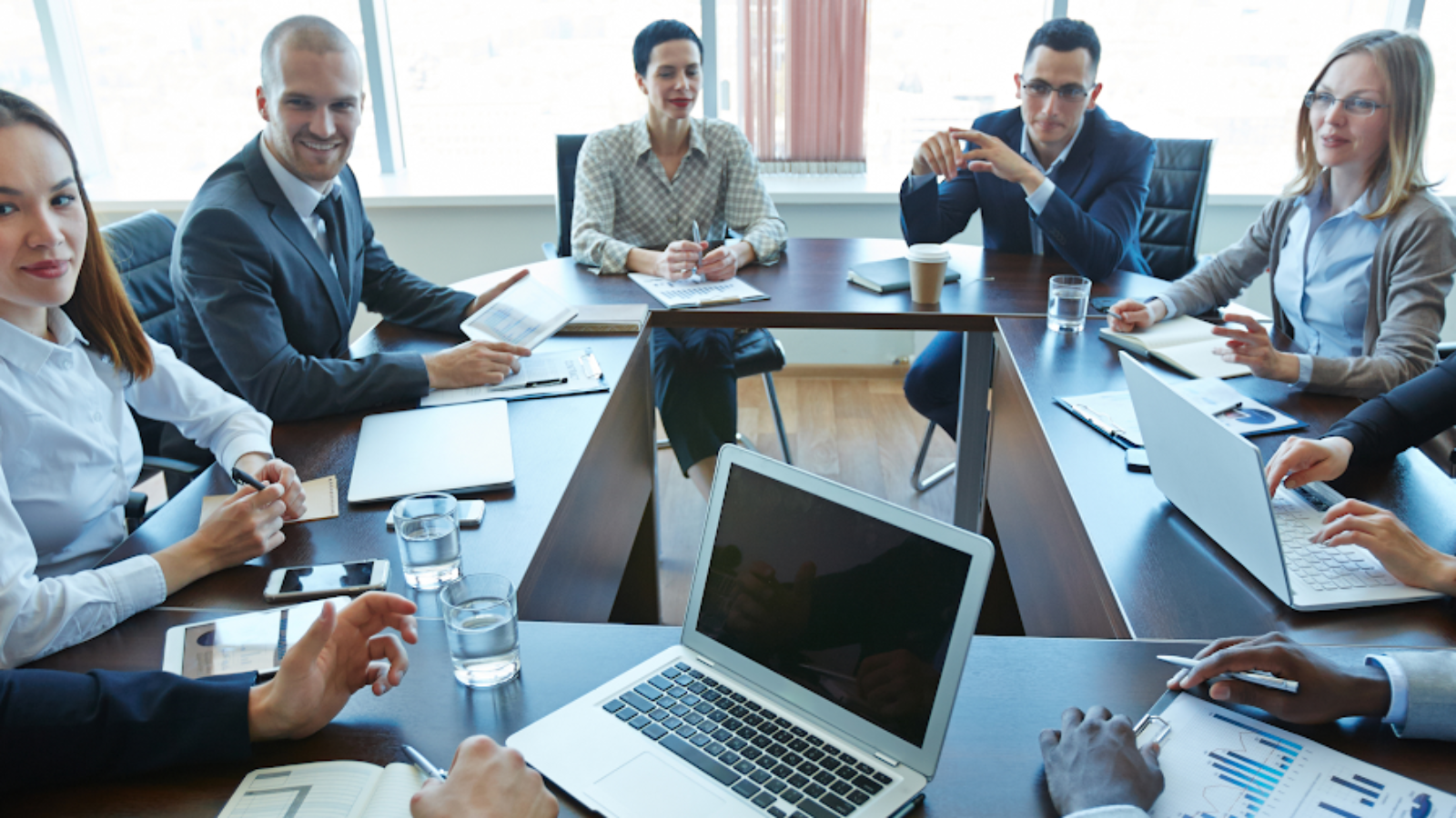 Airline executives in boardroom discussing NDC aggregator partnerships and distribution strategy.