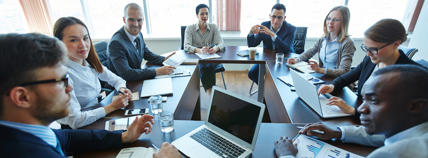 Airline executives in boardroom discussing NDC aggregator partnerships and distribution strategy.
