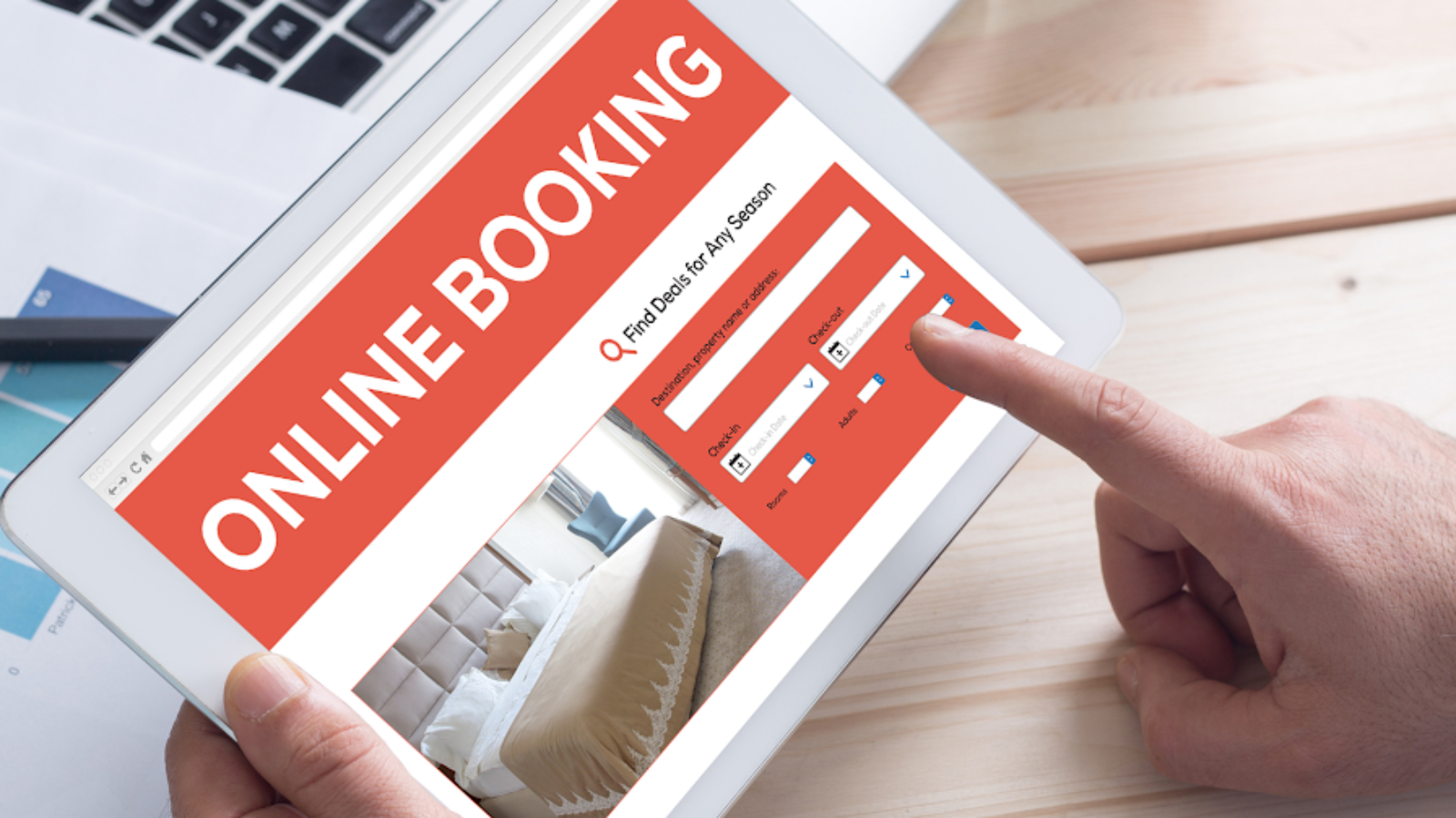 Traveler using online booking system on tablet to create dynamic travel packages for hotels and flights.