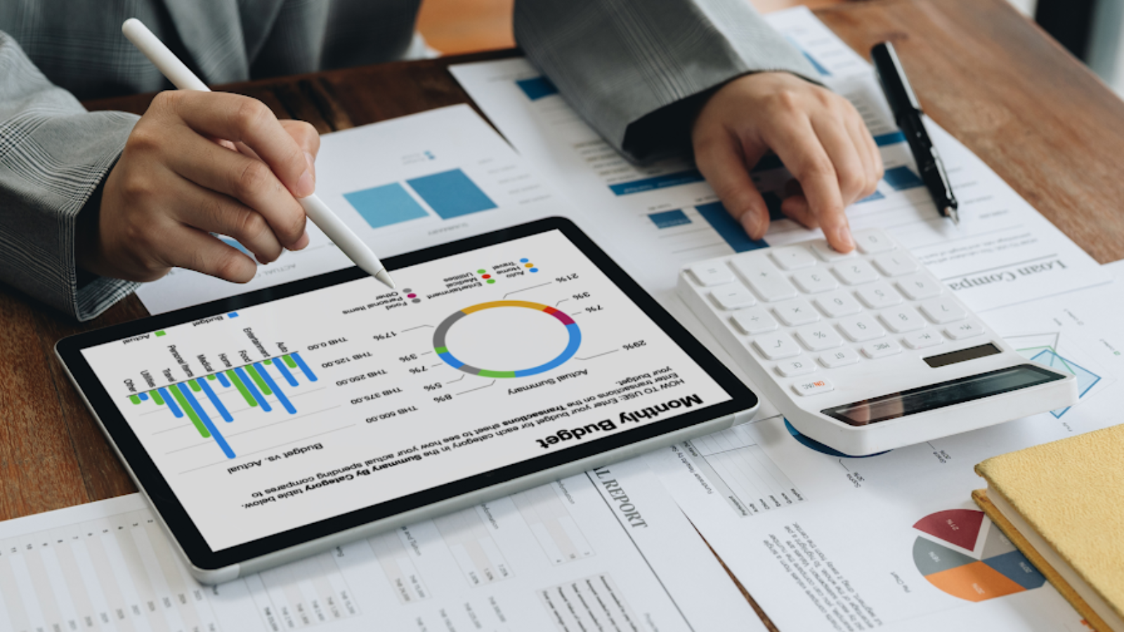 Travel manager analyzing budget charts on tablet and calculator to optimize profits with 80/20 rule.