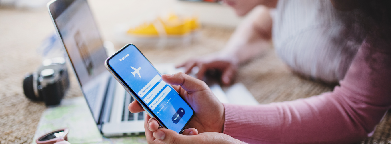 Business traveler using mobile app to book, cancel, and reschedule flights seamlessly.