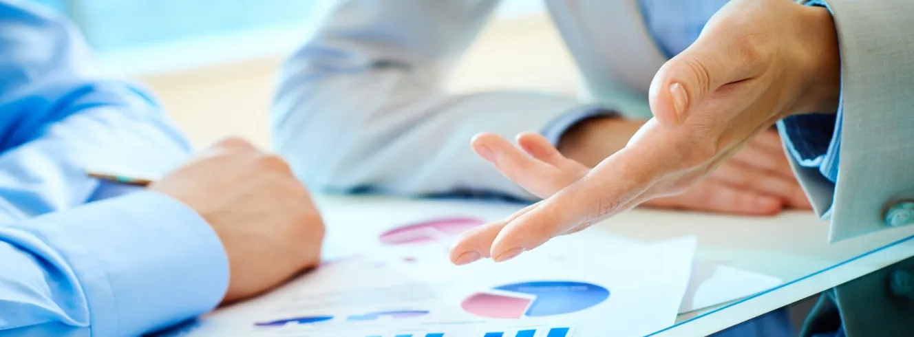 Travel agency managers reviewing performance reports with analytics charts