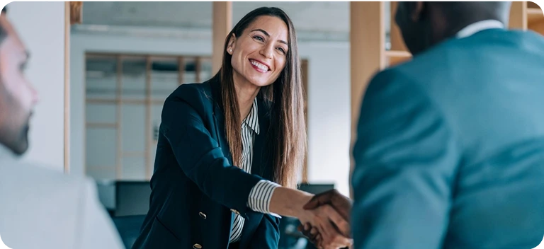 Businesswoman shaking hands with global partner symbolizing international expansion